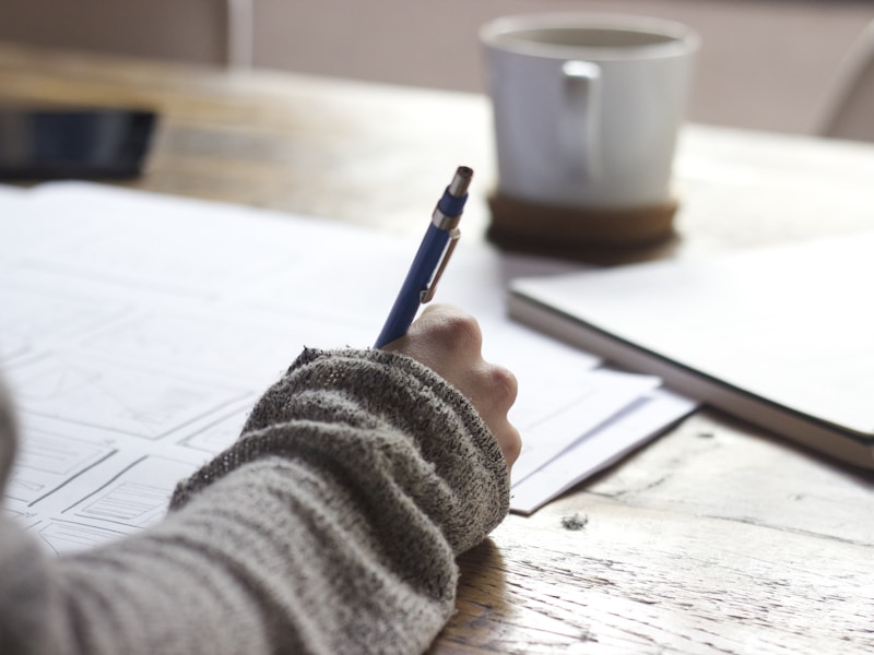 Student studying for an exam with notebook and pen